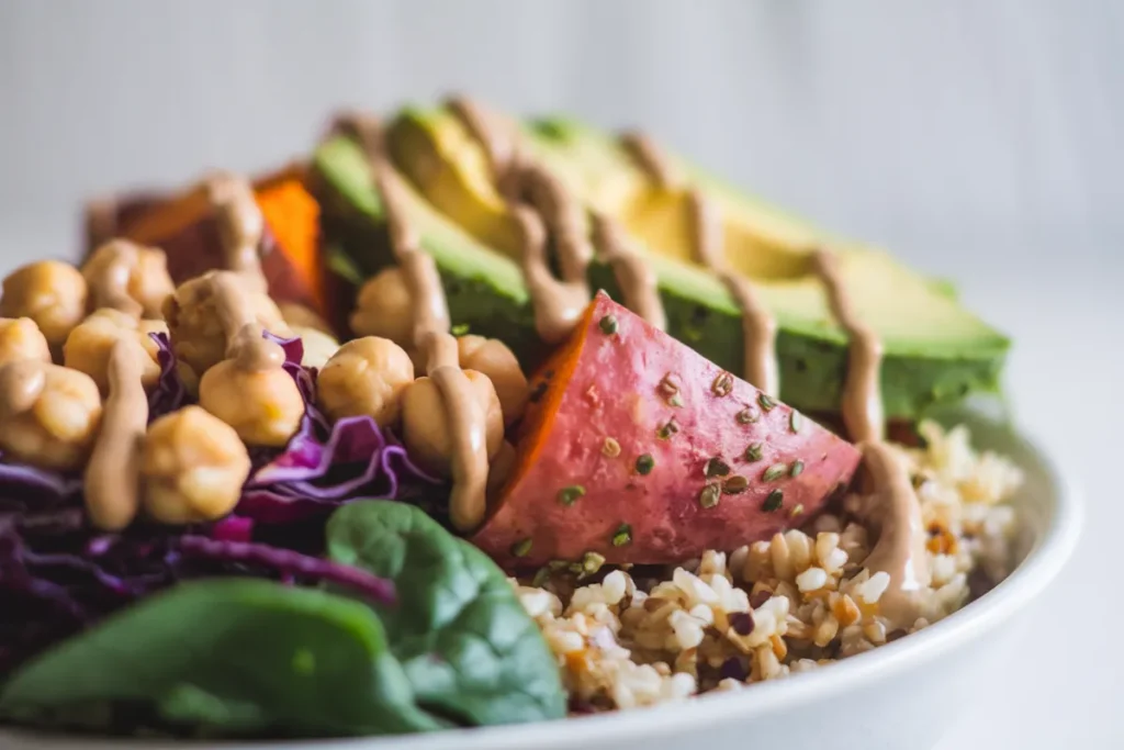 A macro bowl and a Buddha bowl side by side, filled with grains, proteins, vegetables, and sauces.