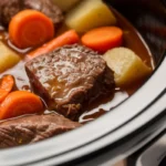 Stew ingredients in a slow cooker on low setting